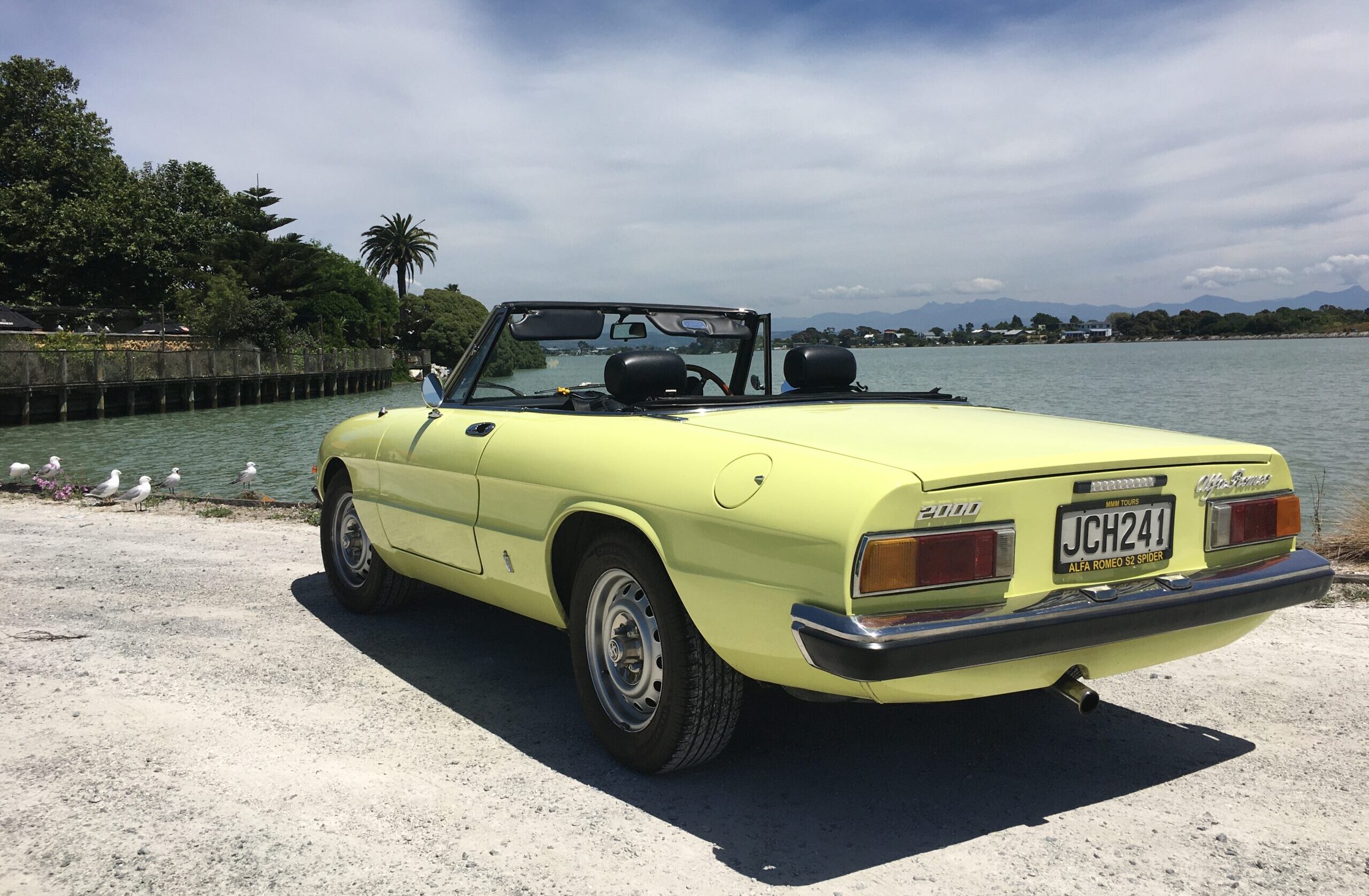 1975 Alfa Romeo Spider rear three quarters shot by sea