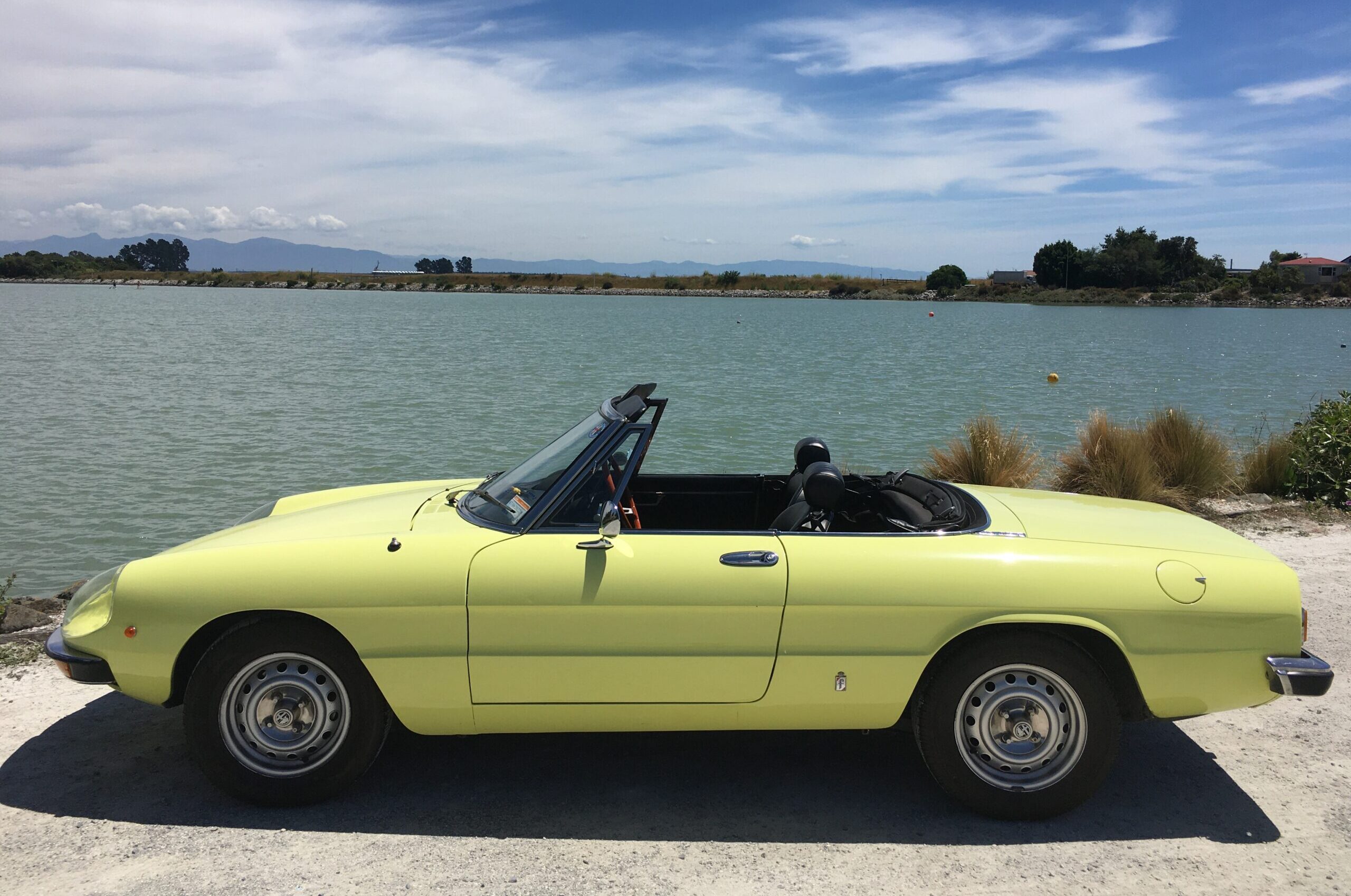 1975 Alfa Romeo Spider side on shot beside the seaside beside the sea